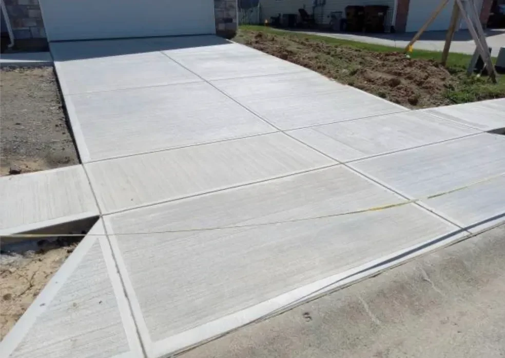 Freshly poured concrete driveway with clean expansion joints