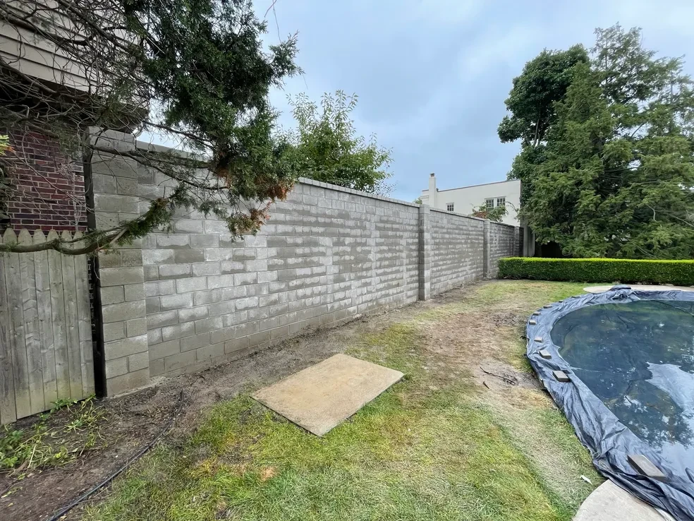 Concrete block retaining wall in residential backyard