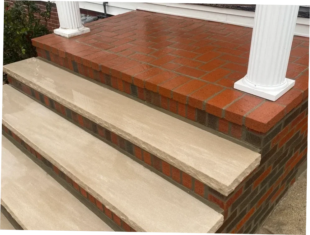 Custom brick porch with bluestone steps and white columns